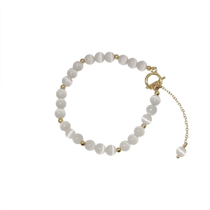 Elegant adjustable white cat eye stone bead bracelet with gold metal accents for women