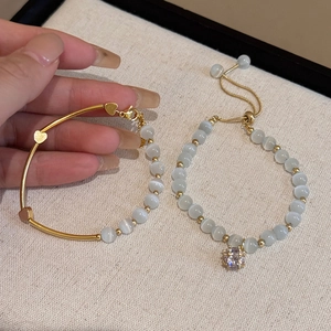 Detailed view of elegant cat's eye stone bracelets with sparkling rhinestone accents.