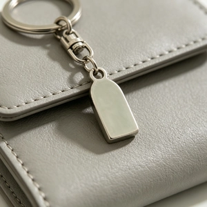 Macro view of a blank stainless steel pendant tag for custom laser engraving.