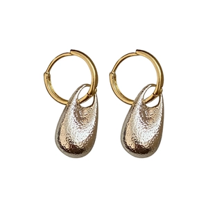 Elegant French style gold hoop earrings featuring uniquely textured waterdrop shaped charms