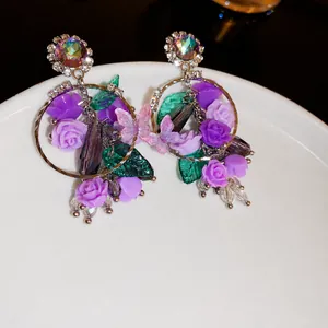 Elegant purple rose and butterfly drop earrings with iridescent crystals
