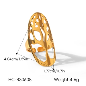 Detailed view of a gold stainless steel ring with an intricate hollow tree branch pattern.