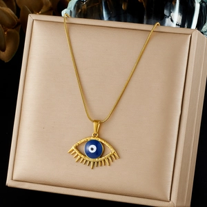 Luxurious gold plated stainless steel necklace with blue evil eye pendant on beige box