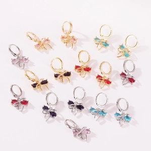 Detailed view of bow knot hoop earrings with multi-color zircons in gold and silver finish