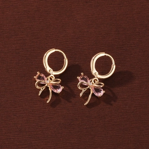 Elegant gold-plated bow earrings featuring sparkling pink teardrop-shaped zirconia