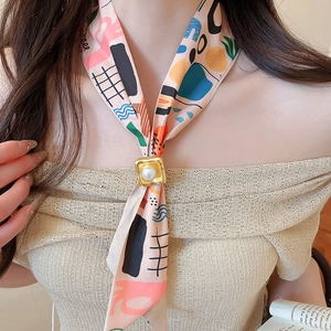 Detailed view of a French tulip pattern silk scarf necklace with elegant pearl gold clasp