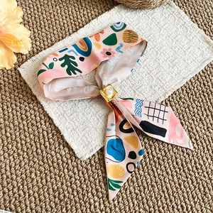Close-up of French style colorful tulip silk scarf necklace with elegant pearl buckle