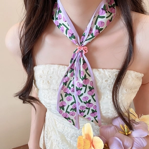 Close-up of a French style purple tulip floral silk scarf necklace with a pink bow