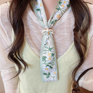 Detailed view of French tulip floral print silk scarf necklace with bow accent