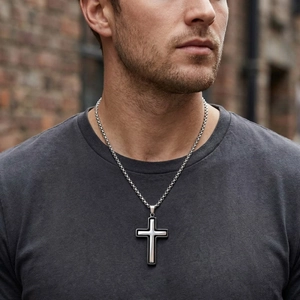 Gros plan d'un pendentif croix rotatif bicolore en acier inoxydable pour homme