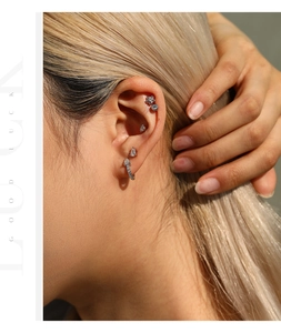 Close-up of S925 sterling silver teardrop moissanite hoop earring on model's ear