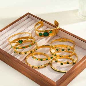 Detailed collection of gold stainless steel bracelets with green hearts and malachite stones.