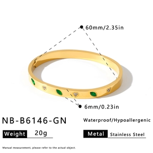 Gold stainless steel heart bangle details with 60mm diameter and green stones.