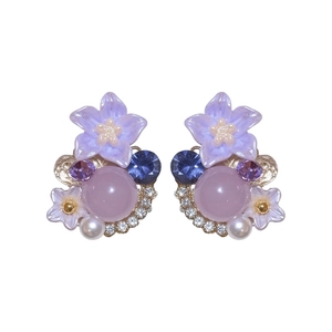 Elegant purple flower stud earrings with crystals and pearls on plain white background.