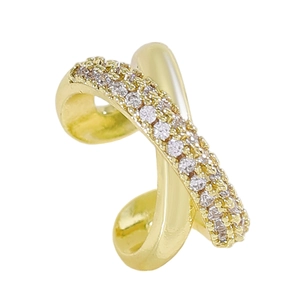 Close-up detail of a gold-plated X-crossed ear cuff with sparkling cubic zirconia