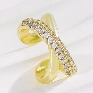 Close-up of gold crisscross ear cuff featuring pavé-set shimmering cubic zirconia stones.