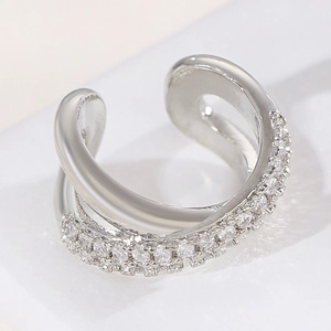 Close-up of silver crisscross ear cuff with pavé-set cubic zirconia stones