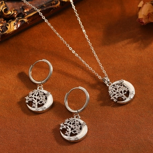Primer plano de conjunto de joyas Árbol de la Vida y luna con detalles de nácar y CZ