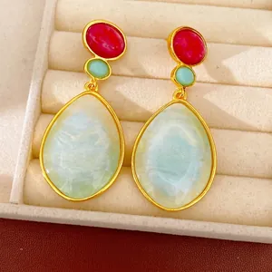 Vintage resin drop earrings with red and blue iridescent teardrop stones in gold metal frame