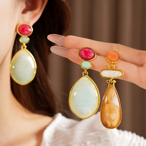 Detailed close-up of vintage resin waterdrop earrings with colorful stone-like textures