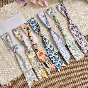 Collection of various floral print skinny silk scarf necklaces with slider rings