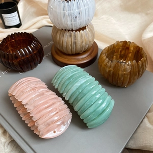 Detailed view of retro acrylic marbled elastic bracelets in various earthy tones.