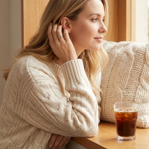 Lifestyle view of a woman wearing gold and silver twisted stainless steel rings