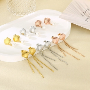 Detailed view of assorted shell-shaped stainless steel earrings featuring pearls and long tassels