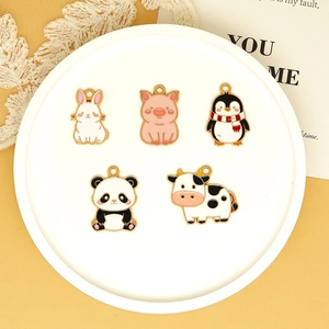 Close-up of five cute cartoon animal enamel charms for DIY jewelry and bag pendants
