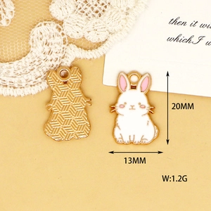Macro detail showing the front and back of the cartoon rabbit enamel charm with measurements.
