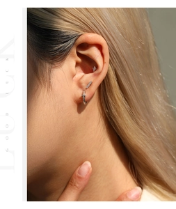 Vista detallada de pendientes de aro y botón de plata esterlina 925 en una oreja