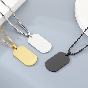 Detailed view of stainless steel dog tag necklaces in gold, silver, and black finishes