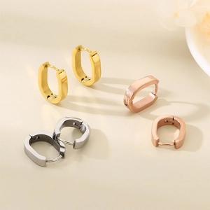 Detailed view of minimalist U-shaped stainless steel hoop earrings in gold, rose gold and silver
