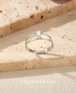 Macro detail of elegant S925 sterling silver double-layer ring with pear-cut moissanite stone