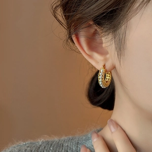 Close-up of elegant French vintage gold hoop earrings with delicate white pearls