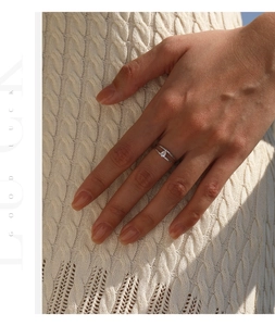 Close-up of minimalist double-layer S925 silver ring with pear-shaped moissanite stone