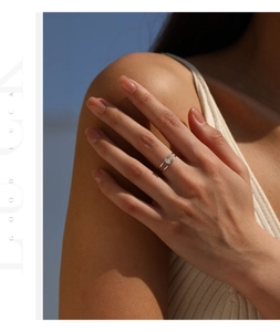 Close-up of a minimalist silver double layer ring with moissanite on model's hand
