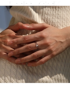 Detailed view of a minimalist double-layer silver ring with a marquise stone