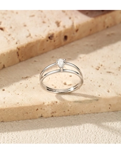 Macro view of minimalist S925 silver double-layer ring with pear-cut stone