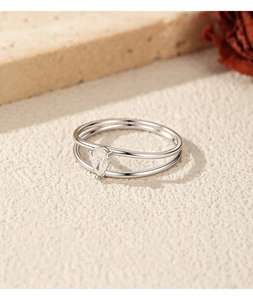 Close-up of a double-layered sterling silver ring with a pear-cut moissanite stone
