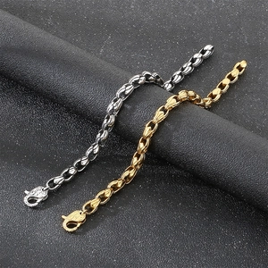 Close-up of silver and gold stainless steel spindle-shaped corn chain bracelets.