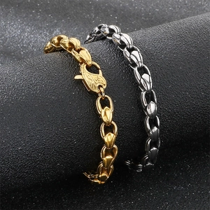 Detailed macro view of gold and silver stainless steel corn chain bracelets with lobster clasps