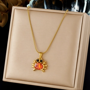 Elegant gold plated stainless steel necklace with orange gemstone crab pendant charm