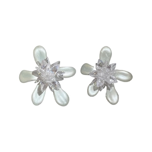 Elegant flower stud earrings featuring white enamel petals and a sparkling crystal center.