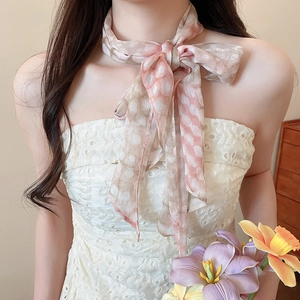 Macro detail of French vintage floral fabric neck scarf with elegant bow knot tie