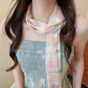 Close-up of a floral print neck scarf necklace on a model for a chic French retro look.