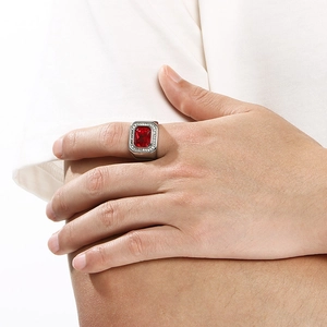 Detail of a men's hip-hop stainless steel ring featuring a large square red gemstone
