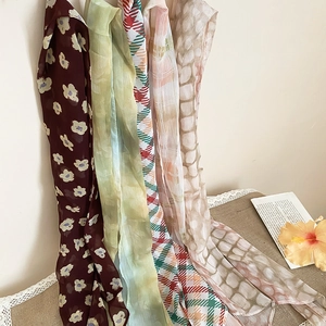 Detailed view of French vintage floral and plaid printed silk scarves in soft tones