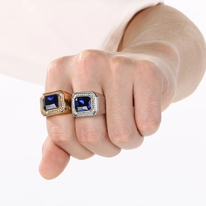 Detailed macro view of men's stainless steel rings with large square blue gemstones