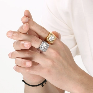 Close-up of men's hip-hop stainless steel square rings with large clear stones on model